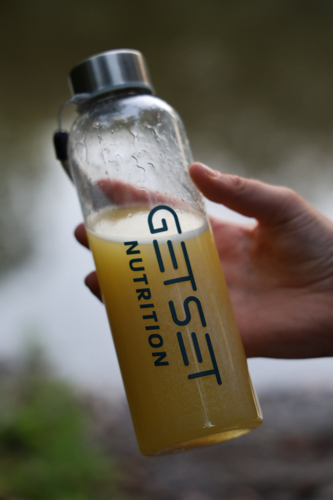 Holding the GETSET Nutrition water bottle with GETSET Complete mixed in